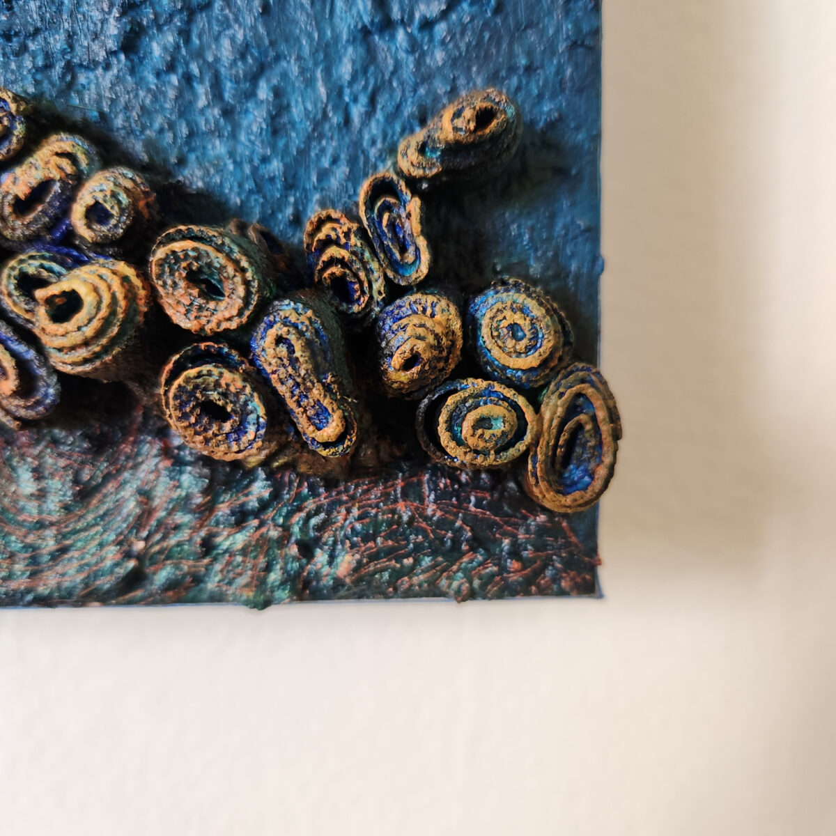 mixed media art. Textured blue with attachments giving a greater 3D effect.