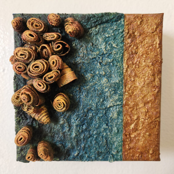 mixed media art. Textured green with attachments giving a greater 3D effect.