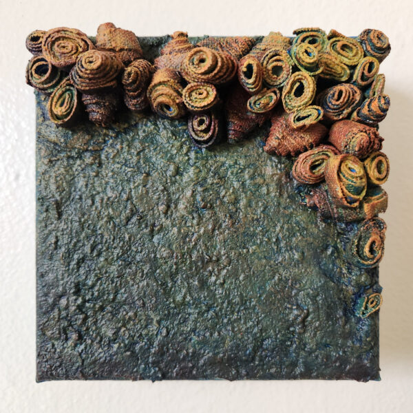 mixed media art. Textured green with attachments giving a greater 3D effect.