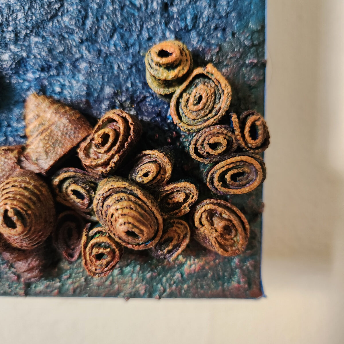 mixed media art. Textured blue with attachments giving a greater 3D effect.