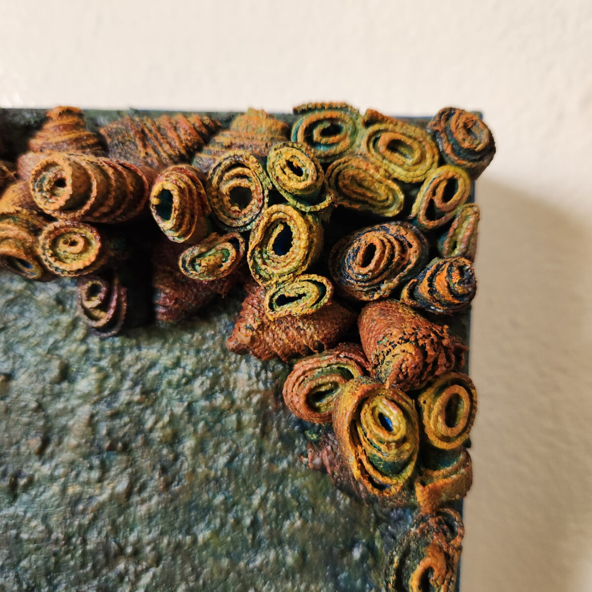 mixed media art. Textured green with attachments giving a greater 3D effect.