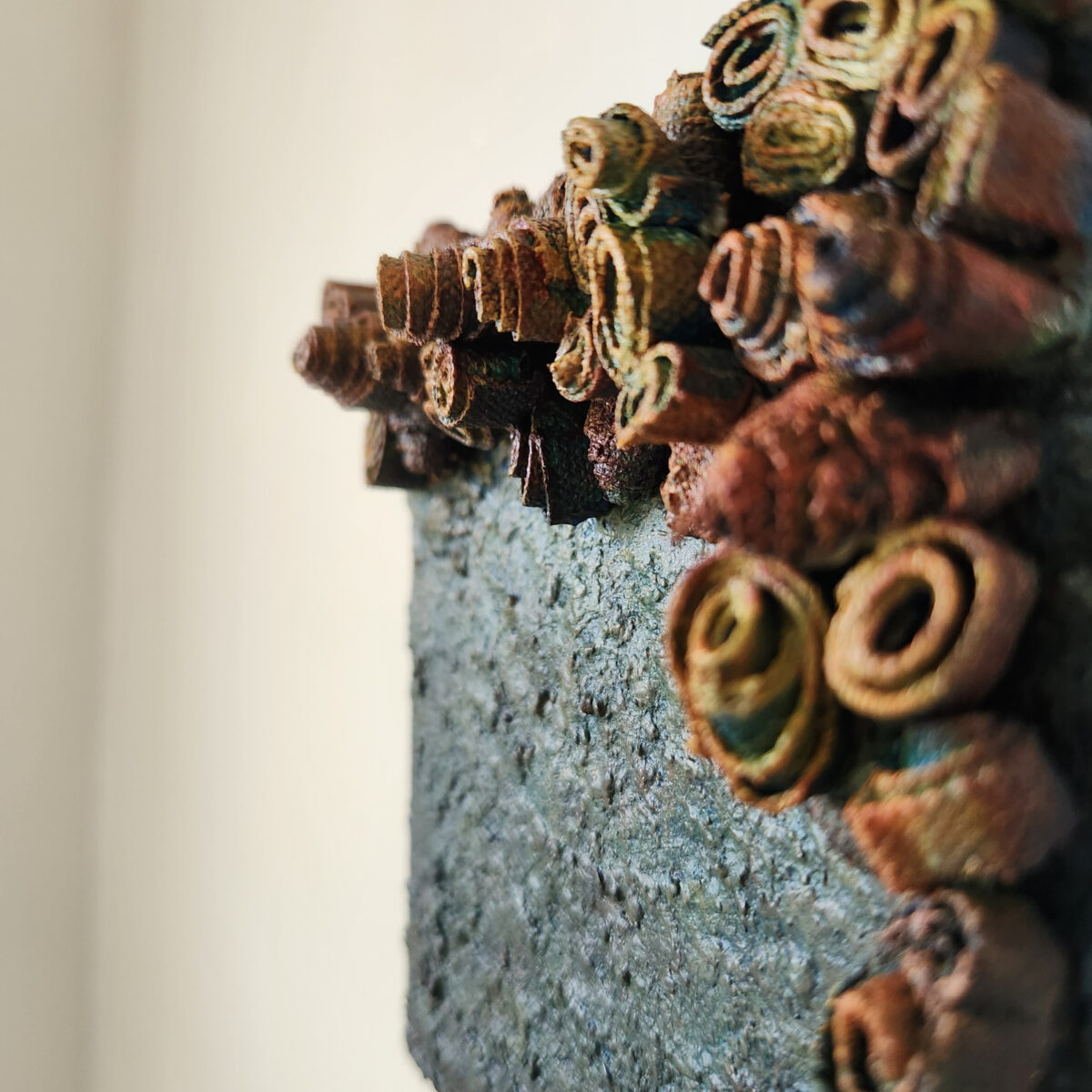 mixed media art. Textured green with attachments giving a greater 3D effect.