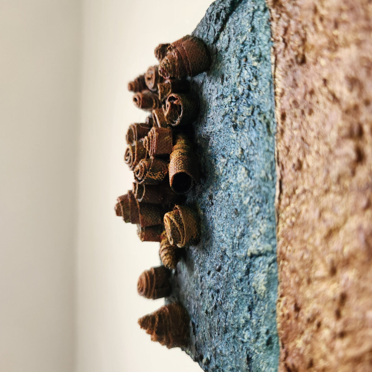 mixed media art. Textured green with attachments giving a greater 3D effect.