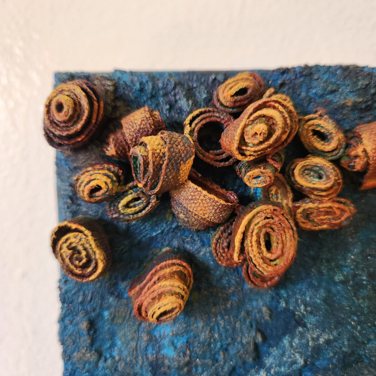 mixed media art. Textured blue with attachments giving a greater 3D effect.