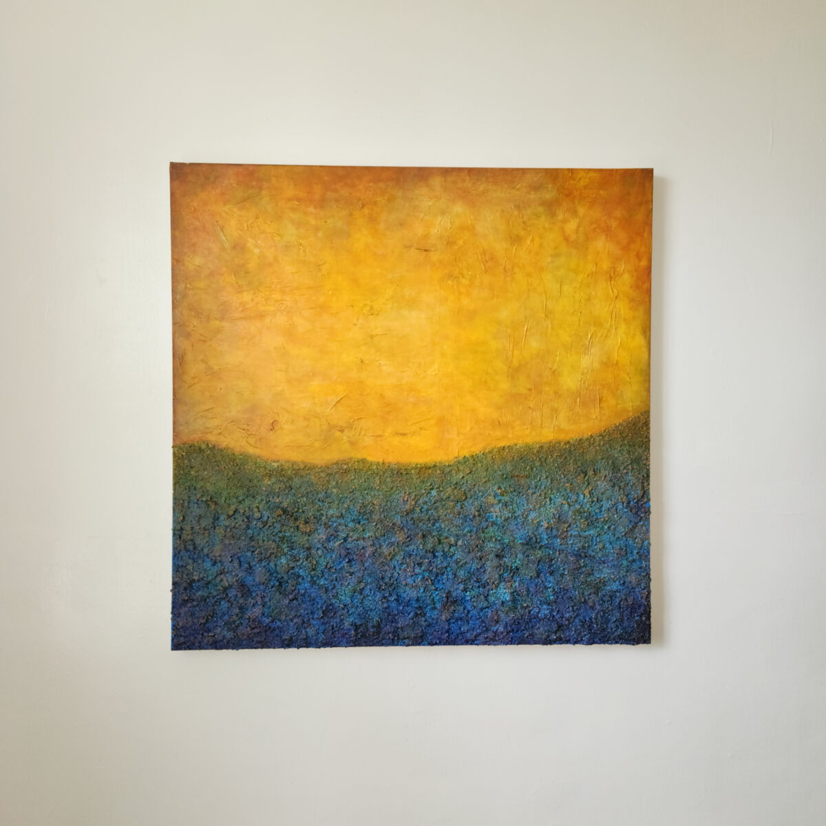 Mixed Media art. Blue texture with light blue elliptical border towards the top. Top is aged orange.