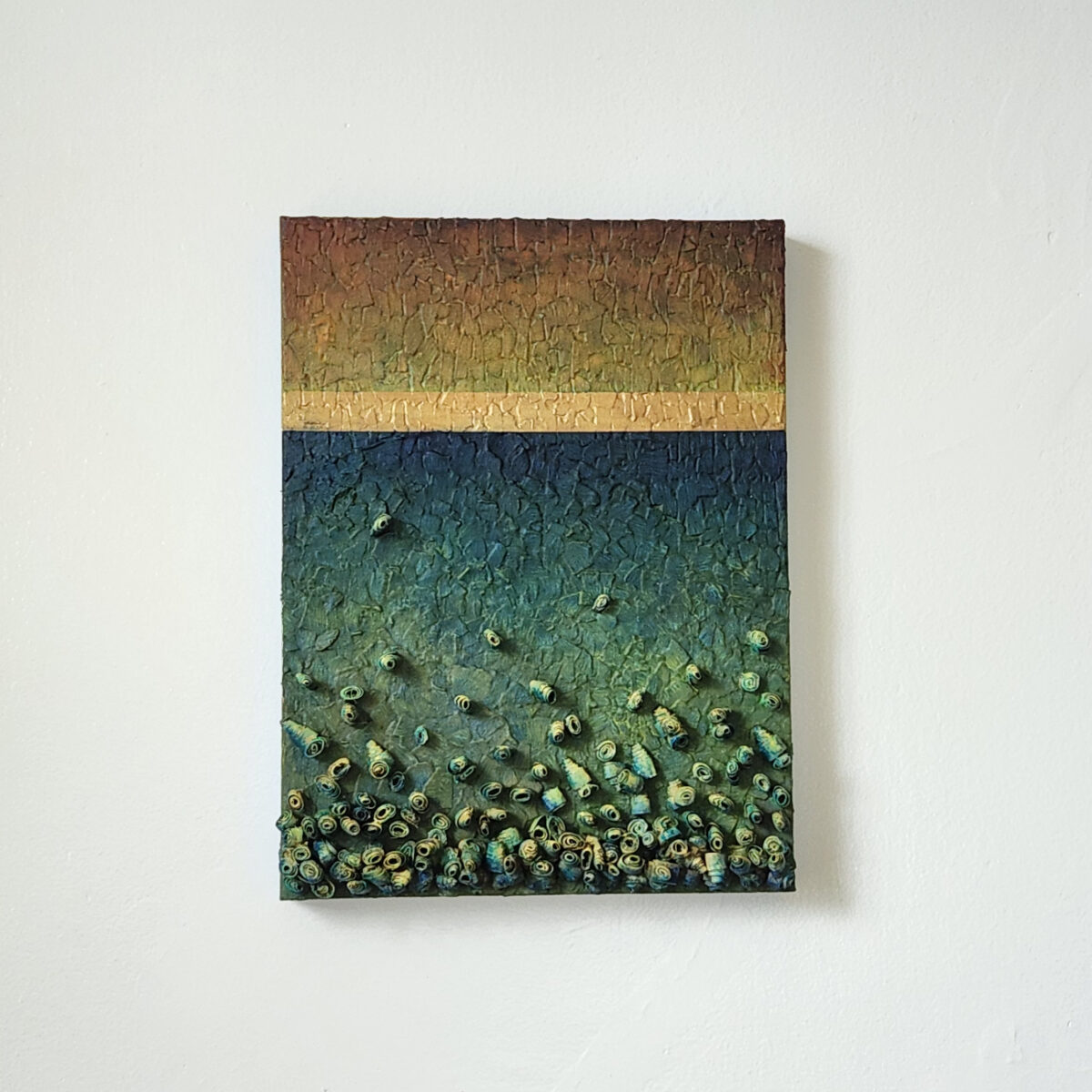 mixed media art. Textured green with attachments giving a greater 3D effect.