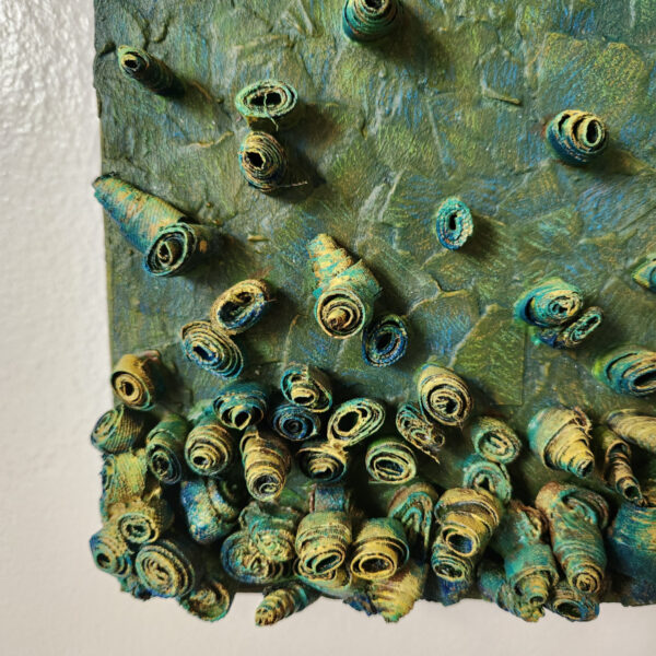 mixed media art. Textured green with attachments giving a greater 3D effect.