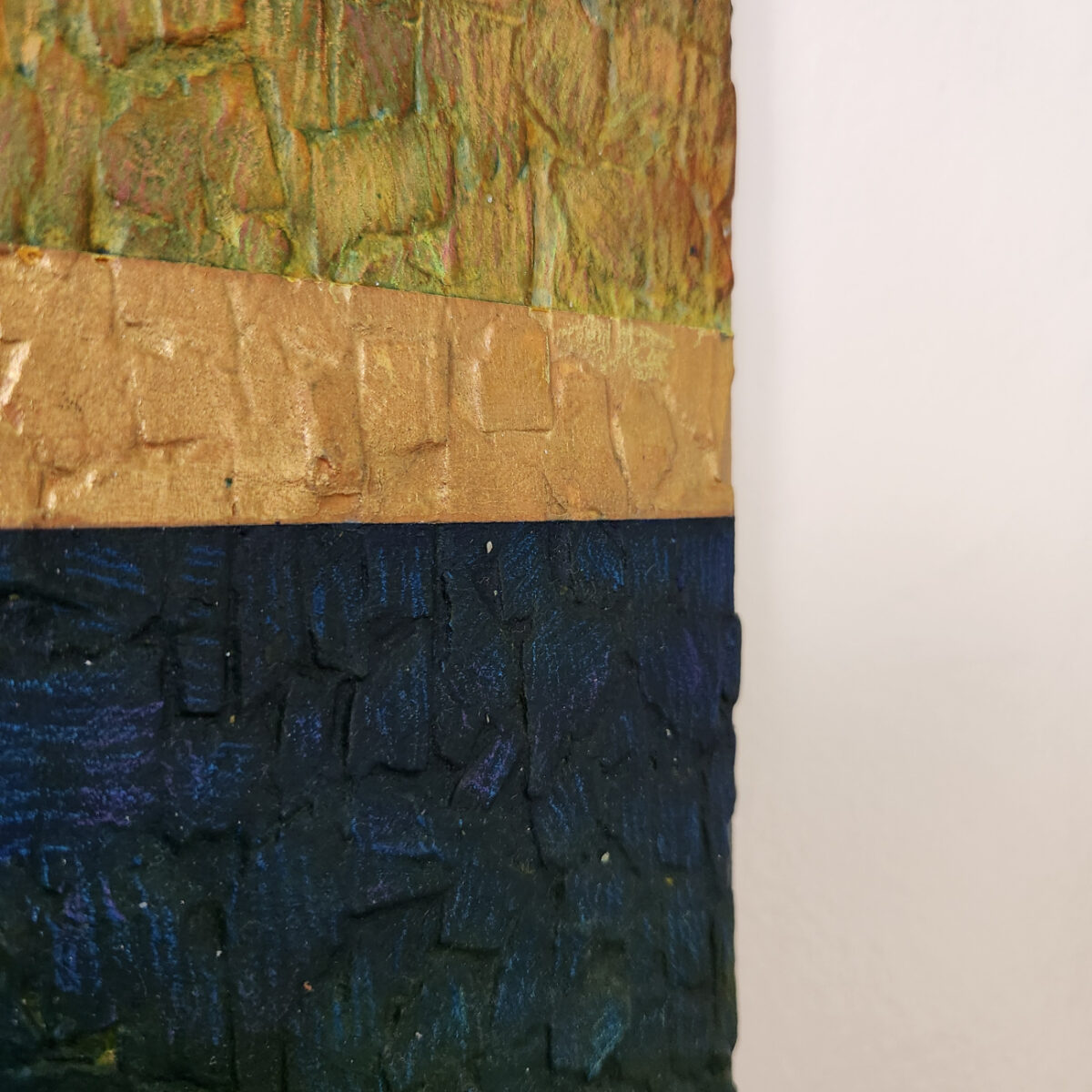 mixed media art. Textured green with attachments giving a greater 3D effect.