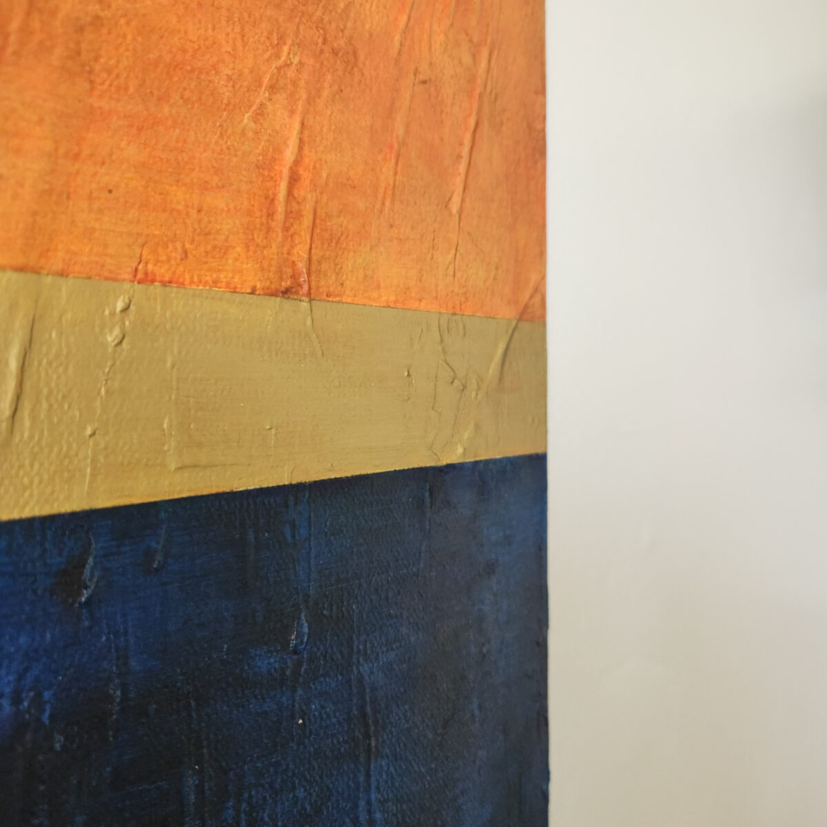 Detail picture: Mixed Media: Textured paintng with a green-blue gradient. Top portion is dived by gold line. Top portion is aged orange.