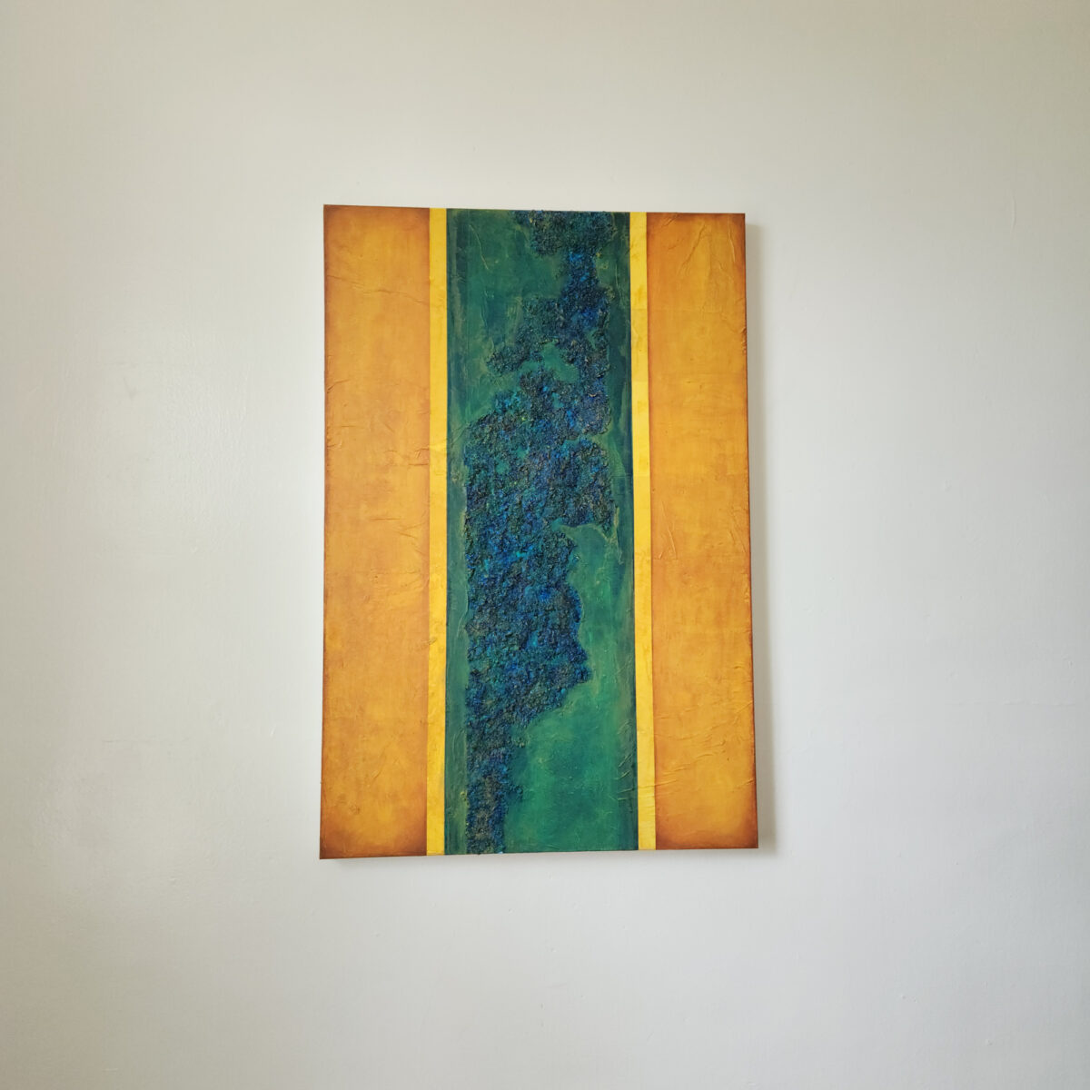 Mixed Media Art. textured green surrounded by aged orange.